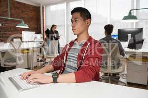 Male executive working on computer in office