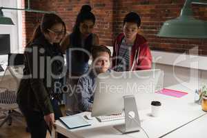 Executives discussing over computer in office