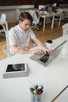 Executive using laptop in office