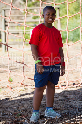 Boy standing in the boot camp during obstacle course training