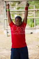 Boy performing stretching exercise during obstacle course training