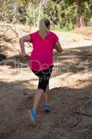 Woman jogging in the boot camp on a sunny day