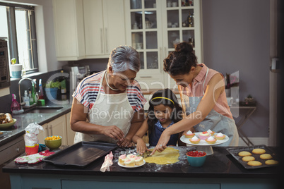 Happy family preparing desserts in kitchen