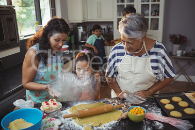 Family preparing dessert in kitchen