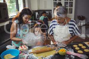 Family preparing dessert in kitchen