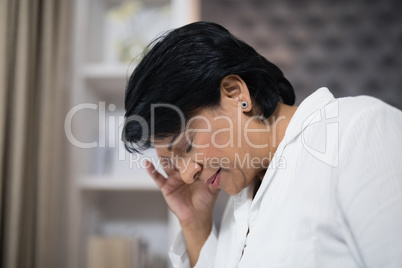 Close up of mature woman suffering with headache