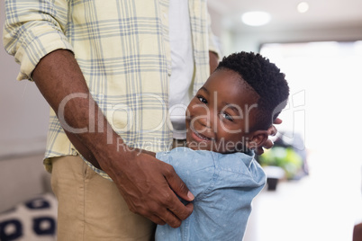 Mid section of happy boy embracing father