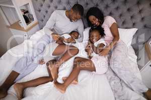 Family enjoying together on bed