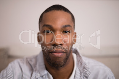 Portrait of confident young man at home
