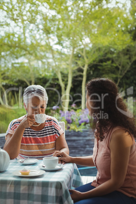 Mother and daughter having tea