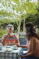 Mother and daughter having tea