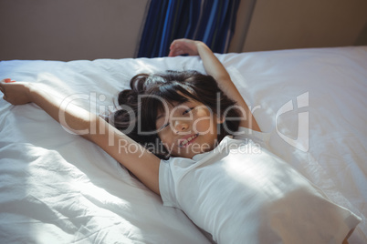 Cute girl lying on bed in the bed room