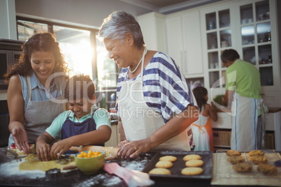 Family preparing dessert in kitchen