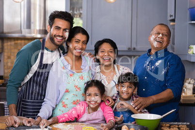Portrait of cheerful multi-generation family enjoying in kitchen