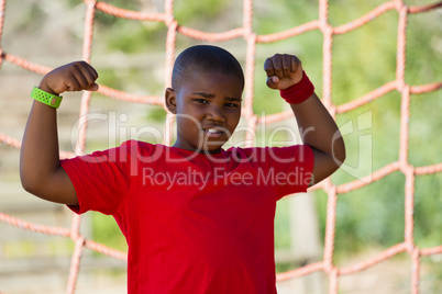 Boy standing in the boot camp during obstacle course training