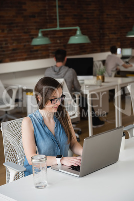 Female executive working on laptop