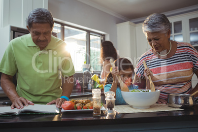 Happy family preparing food in kitchen