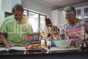 Happy family preparing food in kitchen