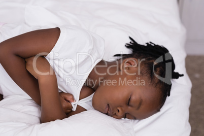 High angle view of girl sleeping on bed