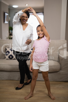 Portrait of smiling girl dancing with grandmother