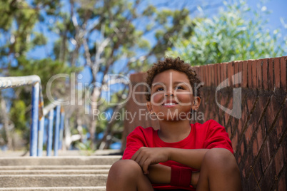 Boy sitting on staircase in the boot camp