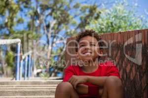 Boy sitting on staircase in the boot camp