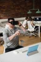 Male executive using virtual reality headset