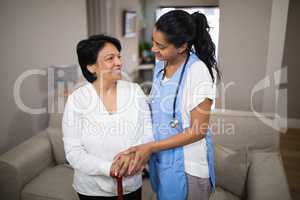 Young nurse standing with patient