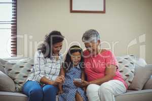 Happy family using mobile phone in living room