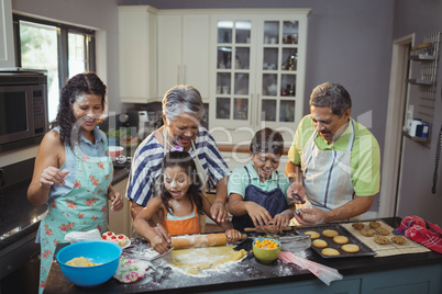 Happy family preparing dessert in kitchen