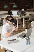 Male executive using virtual reality headset