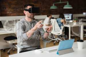 Male executive using virtual reality headset