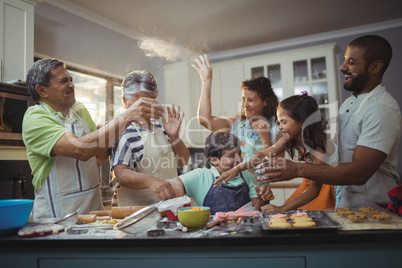 Happy family preparing dessert in kitchen