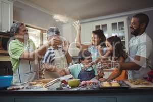 Happy family preparing dessert in kitchen