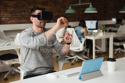 Male executive using virtual reality headset