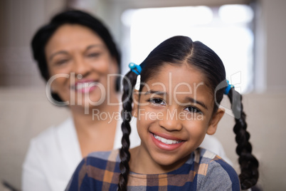 Portrait of smiling girl with grandmother in background