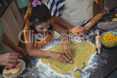 Family preparing dessert in kitchen