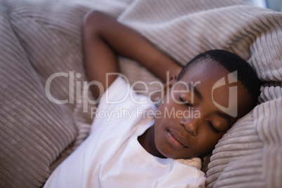 High angle view of boy sleeping on couch