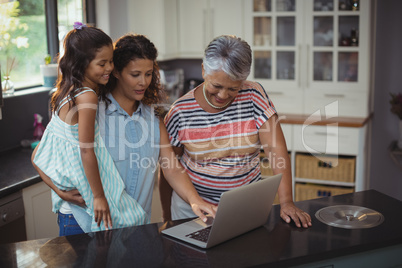 Happy family using laptop in kitchen Happy family using laptop in kitchen