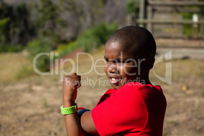 Boy performing stretching exercise during obstacle course training