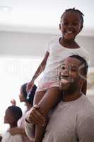 Happy father carrying carrying daughter in bathroom at home