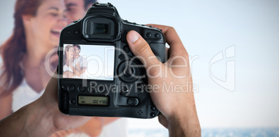 Composite image of cropped image of hands holding camera