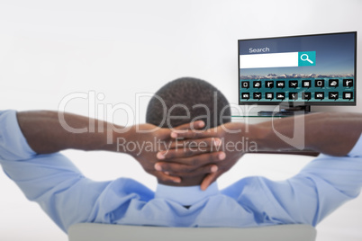 Composite image of rear view of man relaxing on chair