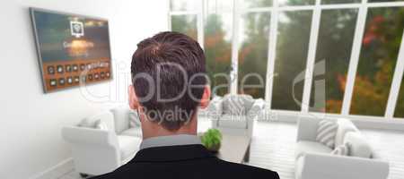 Composite image of rear view of businessman in suit standing