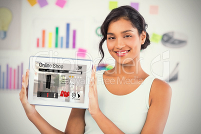 Composite image of happy businesswoman showing digital tablet in creative office