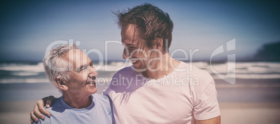 Happy family standing at beach