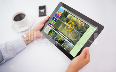 Composite image of man using tablet pc