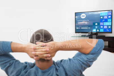 Composite image of rear view of busnessman relaxing on chair