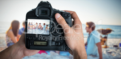 Composite image of cropped image of hands holding camera