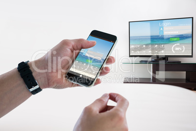 Composite image of close-up of man holding mobile phone